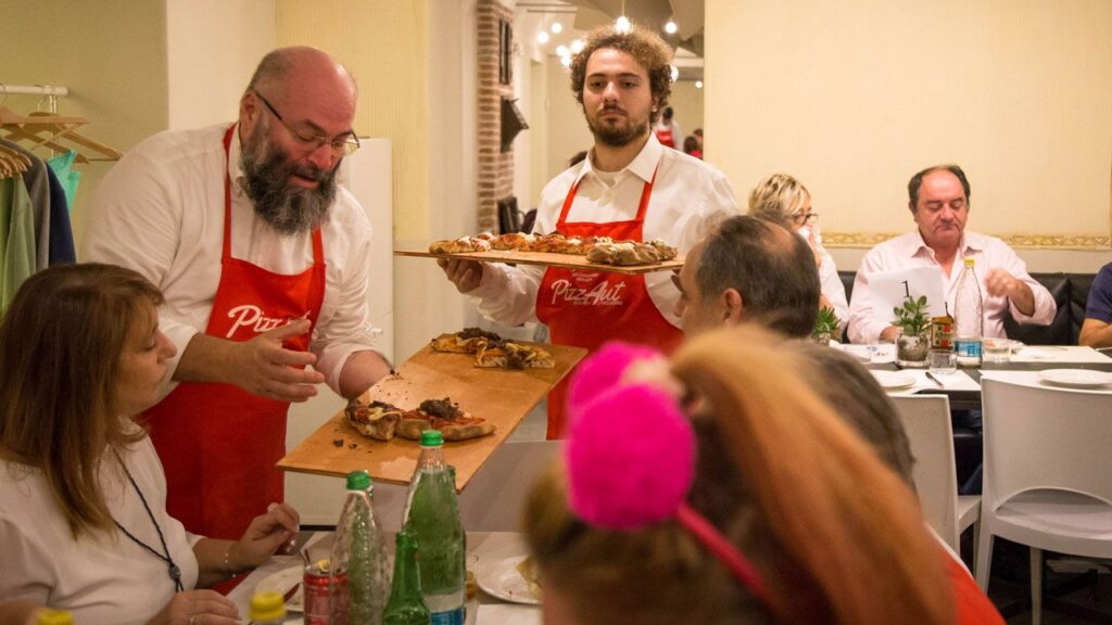 i ragazzi di PizzAut servono la pizza alla Villa reale di Monza